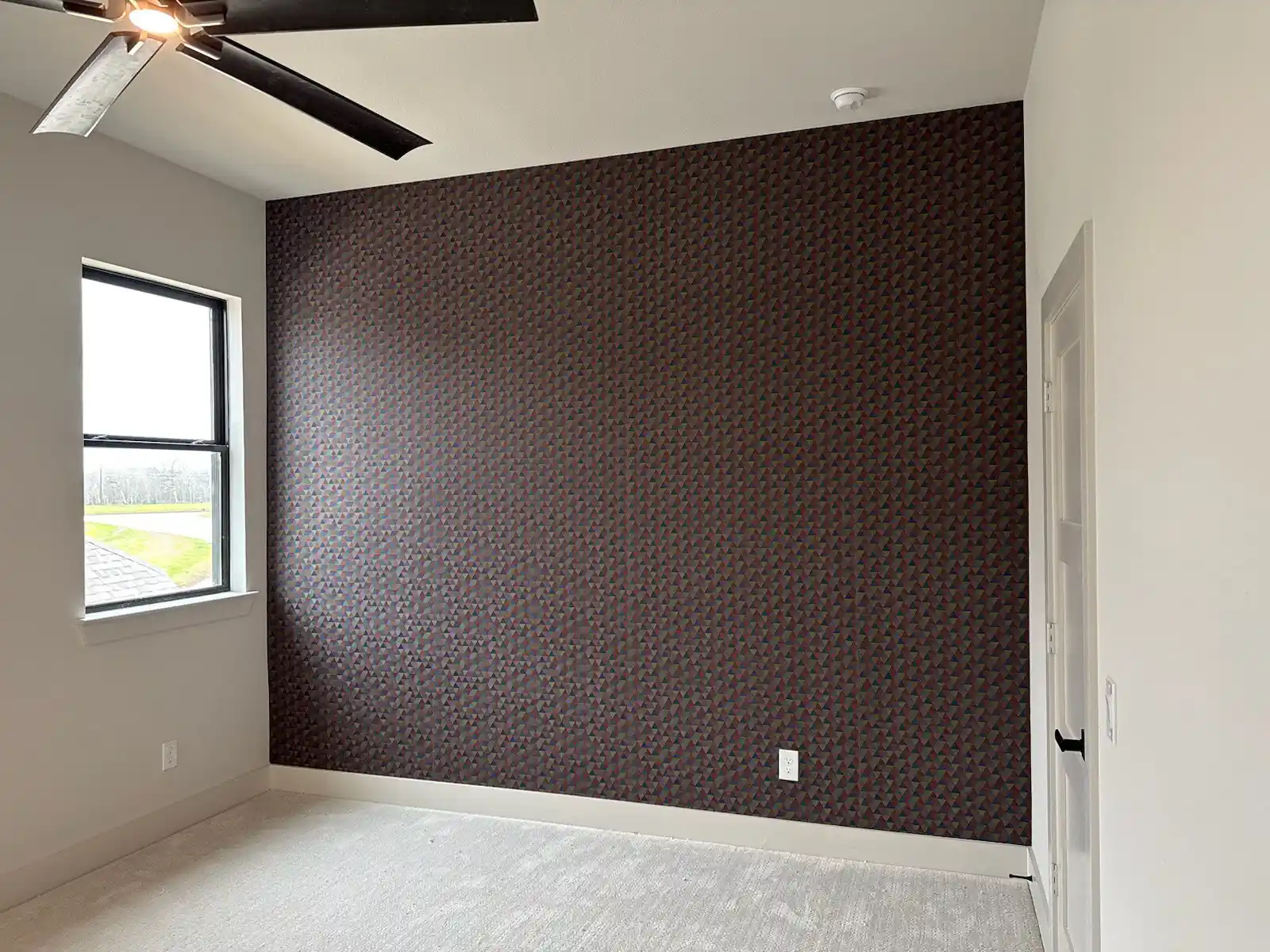 Floral wallpaper installation in master bathroom